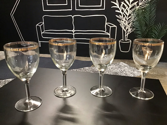 Set of four wine glasses with decorative gold rim